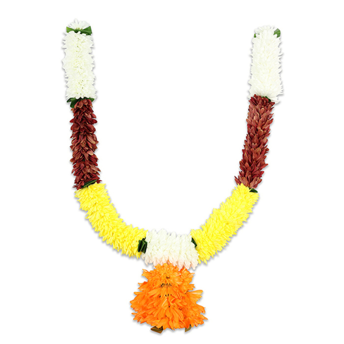 This U-shaped festive garland is presented against a plain white field so the craftsmanship and palette are unmistakable. At the top of each arm a vertical cluster of soft, creamy-white blossoms-small, compact, chrysanthemum-like pom-poms-forms a delicate, luminous cap, with small green accents marking the joins as if to mimic fresh foliage. Immediately beneath these pale crowns, bands of deep reddish-brown elements appear, their flattened, layered textures suggesting dried petals or mahogany-hued silk that lend weight and richness to the piece. The garland flows downward into a generous expanse of golden yellow: tightly packed, fluffy marigold-like clusters that form the main U-curve and convey warmth, prosperity, and celebration. Anchoring the composition at the lowest point is a large, multi-layered pendant of vivid orange ruffles, built up into a rounded, almost pom-pom form that provides a strong central focus and a joyful flourish. The materials are clearly artificial-soft textile petals and secure threading-chosen for resilience and repeated use while convincingly echoing fresh floral shapes. Lighting is even and neutral, emphasizing the saturated hues and the gentle shadow between layers, and the tactile sense of silkiness and fullness is easy to imagine from the image. This toran reads as both devotional and decorative: well suited to puja altars, temple doorways, wedding mandaps and festive home entrances across Mill Hill and nearby Mill Hill Park. The segmented colour bands, neat green junctions and generous orange pendant reflect a florist's eye for balance and tradition, an approach familiar to florists serving the NW7 neighbourhood.