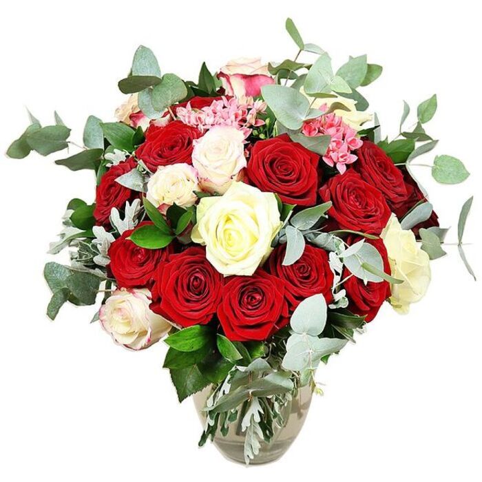 In front of a crisp, white backdrop, a sumptuous rose bouquet is displayed in a transparent glass vase, every colour and texture rendered in clear, even light. The arrangement is rich with deep red and scarlet roses, numbering two dozen or more, their petals luxuriously velvety and layered. Some blossoms remain partially closed, while others are fully open, creating a dynamic rhythm that suggests unfolding romance and heartfelt emotion. Threaded among the red blooms are refined white and creamy ivory roses, along with a few white roses delicately brushed with pale pink at the outer petals, lending a soft glow that balances and lifts the deeper tones. Small tufts of bright pink filler flowers appear throughout the composition, adding fine texture and a gentle pop of colour that keeps the eye moving across the bouquet. Encircling the roses, elegant sprigs of blue-green eucalyptus with distinctive rounded leaves introduce a cool, silvery note, evoking a light, refreshing scent and providing a contemporary frame for the classic blooms. Dark green foliage and occasional silvery-green accents fill and support the design, rounding it into a generous, domed shape that feels both abundant and carefully curated. The glass vase itself has a subtly bulbous base tapering toward a narrower neck, holding the visible stems in clear water, which reinforces the sense of freshness and clean craftsmanship. With no other elements in the scene, it is easy to imagine this bouquet placed on a polished table in a Mill Hill home near Bittacy Hill, or arriving as a romantic delivery to a house close to Mill Hill East station, marking anniversaries, Valentine's Day, or any cherished celebration with a touch of timeless elegance.