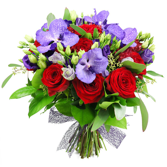 An opulent, romantic celebration in floral form, this bouquet is a masterclass in colour and texture, assembled by skilled hands in Mill Hill. The heart of the arrangement is a cluster of fully bloomed red roses, their velvety petals forming deep spirals of passion, while purple Vanda orchids rise like exotic accents with their broad petals lightly speckled in lavender and violet. Among them, delicate lisianthus in soft purples add a silk-like softness and a generous sense of movement as some blooms hover in and out of view. The greens that surround the blooms are abundant-large, glossy leaves provide a rich backdrop, and slender sprigs add air and rhythm-giving the arrangement its generous volume. The stems are tied at the base with a dark, open-weave mesh ribbon that brings a contemporary edge to the timeless palette. This composition is crafted to evoke romance and celebration, making it perfect for anniversaries, a sumptuous dinner party, or a grand birthday surprise. Delivered with care from Mill Hill to nearby neighbourhoods such as Mill Hill East and Finchley, it arrives fresh and ready to impress. The bouquet is a statement piece that speaks of refined taste, thoughtful design, and the artistry of a local florist who understands how light, scent, and color can mingle to create emotion.