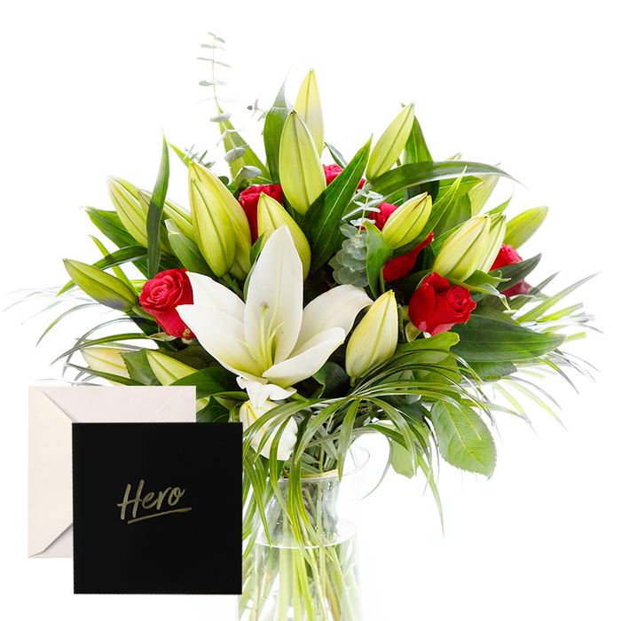As a florist, there is joy in blending the bold with the serene, and this arrangement embodies that harmony. White lilies drift at the heart of the bouquet, luminous and airy, their satin petals contrasting with the tactile, lush greenery that encircles them. Rich, ruby roses punctuate the design, each one a symbol of love and respect, while verdant leaves provide a cooling backdrop and unopened lily buds suggest anticipation and new beginnings. In soft, natural light the bouquet feels alive and uplifting, perfect for honouring someone's strength or celebrating a significant achievement. The accompanying card makes this gesture feel both intimate and enduring, especially when delivered to a Mill Hill home near Mill Hill Broadway or the local community hall.

The bouquet sits in a clear glass vase, its stems bound with a discreet wrap, allowing the flowers to breathe and the greenery to tell its quiet story. In Mill Hill, this design travels well, with careful wrapping to protect the aroma during delivery, and it can be sent to mark a milestone, offer support, or honour a major achievement. It says you are remarkable, you are valued, you are honoured by those who love you. A thoughtful choice for any occasion that deserves a dignified tribute, crafted by Flowers Mill Hill for the Mill Hill community.