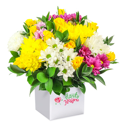 A full, rounded bouquet, rich with texture and colour, rises from a minimalist white square box set against an all-white background, allowing the flowers to command every bit of attention. At first glance, the eye is drawn to the golden-yellow chrysanthemums that dominate the centre, their tightly layered petals creating plush, cushion-like blooms. Around them, small yellow spray roses and delicate rosebuds peek out, some still furled, others beginning to unfurl, giving the arrangement a sense of gentle movement and growth. Interwoven are clusters of white daisy-style flowers with neat green centres and fluffy white chrysanthemums, their soft, cloud-like shapes bringing lightness and balance. Through this tapestry of yellow and white, vivid fuchsia and magenta chrysanthemums cut a playful path, some with subtle variations of lighter pink at the petal edges, adding depth and a hint of drama. Dark, glossy foliage frames the base and surfaces here and there among the flowers, much like the lush greenery of Mill Hill's gardens and nearby green spaces, anchoring the bouquet and highlighting the brightness of the blooms. The white box is cube-shaped and contemporary, an ideal container for easy placement on a hall console, café counter, or office table near Mill Hill Broadway. The arrangement appears carefully composed by an experienced florist, with heights balanced and colours thoughtfully spaced. This is the sort of bouquet that would suit a family celebration in a Mill Hill home, a congratulatory gift for a new baby, or a simple "thinking of you" sent with same-day delivery across NW7, radiating warmth, optimism, and everyday elegance.