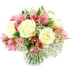 Set against a crisp, white studio backdrop, this beautifully composed bouquet forms a gentle dome of creamy white roses, bright pink alstroemeria, and delicate baby's breath, all anchored by a tight cluster of green stems at the base. The roses command attention: large, perfectly formed blooms whose petals are arranged in layered whorls, opening outwards from pale yellow-tinted centres to soft ivory edges. Their smooth, velvety texture suggests the cool touch of fresh petals early in the morning. Around and between them, alstroemeria blossoms add a lively, uplifting energy. Each stem carries several trumpet-shaped flowers, their petals blending blush and fuchsia tones with fine burgundy streaks along the inner surfaces, creating depth and visual interest. Fine sprays of gypsophila weave through the bouquet like a delicate lace, tiny white flowers clustering together to soften the stronger shapes and colours. Deep green leaves peek out beneath and between the blooms, framing the flowers and echoing the greenery you might see along the paths in Mill Hill Park. The stems at the bottom are bundled neatly and cut to a uniform length, revealing that this is a hand-tied design prepared with professional care, perhaps moments before being delivered to a home off Flower Lane or Lawrence Street. The lighting is bright and even, without harsh shadows, highlighting each petal edge and the subtle colour shifts in the arrangement. The overall mood is soft, romantic, and quietly celebratory, perfect for sending love, thanks, or congratulations to someone special in Mill Hill who appreciates timeless floral elegance.