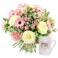 This tender image presents a carefully arranged Mother's Day-inspired gift set on a clean white background, echoing the calm, bright interiors of many Mill Hill homes. On the left, a rounded, hand-tied bouquet rests naturally, its stems neatly bunched and visible beneath the blooms. The flowers create a soft melody of colour: cream and pale yellow roses open generously, their layered petals giving a plush, almost velvety look, while ruffled blush-pink carnations provide playful texture. Smaller, deeper pink spray roses sit between them, some in full bloom and others still in bud, suggesting new moments still to come. Cheerful, mid-pink gerbera daisies with dark chocolate-brown centres act as joyful focal points, and slender white alstroemeria with delicate reddish streaks drift outward like graceful strokes of a brush. Throughout the bouquet, airy white baby's breath forms light, cloud-like clusters that soften the stronger shapes and tones, while sprigs of fresh green foliage peep out, evoking the greenery of nearby Mill Hill Park and leafy suburban streets. To the right of the flowers is a pristine white ceramic mug, upright and clearly presented, with a smooth glaze and comfortable handle that invites daily use. The design on the mug shows a soft, watercolour-style pink heart, inside which the phrase "WORLD'S BEST Mum" is arranged: the upper words in simple black type, and "Mum" in a shimmering gold or rose-gold script that feels both modern and sentimental. The overall lighting is bright and even, giving the scene a fresh, uplifting quality. Together, the floral arrangement and mug evoke gratitude, love, and quiet celebration, an ideal gift to be delivered to a special mum in Mill Hill or the wider North London area.