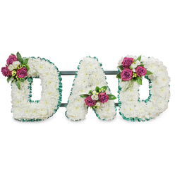 Presented against a pure white background, this handcrafted sympathy tribute spells DAD in large, three-dimensional letters made from tightly clustered white chrysanthemums, their soft, pillowy heads creating a continuous, serene canvas. Each letter's rim is crisply defined by a pleated emerald-green ribbon that adds a formal, respectful outline and a cool visual counterpoint to the warm white blooms. The letters are supported by a subtle dark green or grey horizontal bar at the back, the kind of discreet frame used for funerals and memorial displays to keep the composition steady when placed on an easel or at a graveside. Positioned with care, three floral clusters add colour and intimacy: rich magenta roses-some just unfurling, some in fuller bloom-are paired with delicate white freesias or small spray blooms and deep green foliage, their scent suggested by the arrangement's fresh, layered textures. The left curve of the first D carries a generous cluster, the A holds its group in the lower central V, and the right curve of the final D repeats the motif for visual harmony. This piece speaks of reverence and personal remembrance, appropriate for wakes, funeral services, or a place-setting at a chapel. As a Mill Hill florist creation available for local delivery around Mill Hill Broadway, Mill Hill Village and nearby Bittacy Hill, Flowers Mill Hill prepares each lettering tribute with attention to balance, freshness and discreet dignity for families seeking a meaningful farewell.