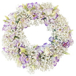 A serene floral wreath designed for sympathy is shown against a crisp white background, which amplifies the purity of its colours and the precision of its circular form. The ring is luxuriously padded with Baby's Breath, so densely layered that their minute white blossoms blend into a continuous cushion, like fine lace wrapping around the frame. From this delicate base emerge ruffled lisianthus blooms, artfully spaced so their presence feels both intentional and effortless. Each lisianthus flower begins in pure white and then gently transitions to purple at the petal edges, displaying shades from soft lilac to richer violet, creating a subtle yet captivating contrast. Some flowers are fully open, their layered petals curling outward to reveal deeper centres, while others remain partially closed, pale green buds brushed with cream that promise future blossoms. The textures alternate between the tiny, feathery lightness of Baby's Breath and the satiny, undulating surfaces of lisianthus petals, adding visual depth even against the simple backdrop. The centre of the wreath remains open and uncluttered, forming a clear window that naturally suggests notions of eternity, remembrance, and the unbroken bond between the living and the departed. It is easy to picture this arrangement being prepared in a Mill Hill flower shop, destined for a funeral service in one of the area's churches or as a tribute laid after a quiet walk through Mill Hill Park. Without any ribbons or bold accents, the wreath relies solely on the gentle interplay of white and purple to convey its message: a dignified, tender farewell crafted to bring a moment of peace and beauty to a sorrowful day.