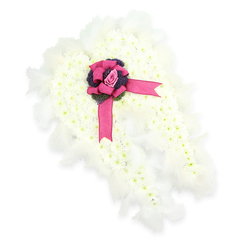 This elegant funeral arrangement is formed into the shape of a pair of angel wings, laid against a flawless white backdrop so the structure and textures are easy to imagine. The main body of each wing consists of countless tiny white blooms, likely spray chrysanthemums, tightly clustered to create a smooth, cloud-like surface that calls to mind early-morning mist over the playing fields around Mill Hill. Slight touches of pale green at the centres of some flowers introduce a fresh, living note amidst the softness of the white petals. Running around the outer contour of the wings is a trim of white feathers, their fine filaments adding movement and an ethereal quality, as though the wings might softly stir with a passing breath. At the central join between the wings, a bold fuchsia satin ribbon is fashioned into a full bow, its lustrous loops and graceful streamers resting gently on the floral surface. Tucked deep within this bow sits a single pink rosebud, exquisitely shaped, its petals still close and protective, reflecting tenderness and cherished affection. Beneath and around the rose, there is a ring of dark purple thistle-like flowers or richly textured foliage, creating depth and a striking colour contrast that anchors the focal point. The overall effect is peaceful yet emotionally resonant, echoing both sorrow and gratitude for a life well lived. Suitable for funeral and remembrance services throughout Mill Hill and nearby areas, this angel wing tribute offers a comforting visual symbol of guidance, protection, and love that continues beyond farewell.