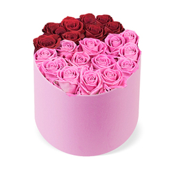 As a local Mill Hill florist, I see this arrangement as modern romance expressed in living color. The roses form a clean, intentional composition, with a deep arc of crimson red at the top cradled by surrounding pinks. The soft pink hatbox adds a tactile softness-velvet under the fingertips-enhancing the sense of luxury. The blooms themselves wear a luscious, open-face look, their petals curling gently inward in protective spirals, creating depth and quiet drama. The design remains neatly balanced: no foliage competes with the blooms, and each stem is spaced to convey quiet abundance rather than crowding. What I love is the instant uplift-the light, symmetry, and the joyful interplay between red and pink-making it ideal for marking a special day, from a milestone anniversary to a beloved birthday, or simply to surprise someone special. A gentle scent lingers, a promise of bloom even as the room fills with warmth. Available for same-day delivery across Mill Hill and surrounding areas, this gift box offers a refined moment that brightens any space, a timeless gesture of love wrapped in luxury. It's the kind of piece to gift when you want to say you are cherished with grace and lasting beauty, a small luxury that resonates beyond the moment.