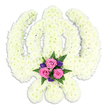 A solemn Sikh Khanda floral tribute is shown in isolation against a bright white background, its entire form brought to life through a meticulous use of flowers. The central double-edged sword is framed by the circular chakkar and flanked by two outward-sweeping kirpans, each element clearly carved out by the placement of tiny white chrysanthemum blooms. These blossoms are arranged so close together that they create an almost seamless, padded surface, the petals overlapping in soft layers. The whites are gently warmed by touches of cream at the heart of some flowers, giving the tribute a natural, comforting feel rather than clinical starkness. At the bottom of the composition, where the kirpans cross, a delicate accent of colour rests like a small bouquet cradled within the emblem. Three open pink roses form the focus of this cluster, their velvety petals curling outwards in generous, rounded shapes that speak of love, gratitude, and farewell. Interspersed among them are small, rich purple flowers that lend an understated depth, while sprigs of fern and other green foliage stretch out slightly, adding movement and life. A faint shadow beneath the Khanda hints at its three-dimensional presence, but there are no other distractions in the frame. This is the kind of floral tribute that might be chosen by Sikh families in Mill Hill, perhaps for a funeral or memorial service near Mill Hill Broadway or along Lawrence Street, where local florists understand both the devotional meaning of the Khanda and the gentle symbolism of white, pink, and purple flowers in times of loss.