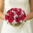 Within the serene glow of a Mill Hill wedding morning, a bride stands poised in her delicately textured ivory dress, bouquet in hand. The arrangement overflows with lush red roses, each bloom exquisitely detailed-a symphony of tightly ruffled petals that almost pulse with life and fragrance. Threaded between the roses, frothy clusters of pure white baby's breath create a light, dreamy aura, their softness lending contrast and grace. A few emerald-green leaves peek modestly from the base, echoing the greenery of Mill Hill's garden walks. The bride's hands, well cared for and steady, provide a tender frame for the bouquet, while the gown's personality-lacework, elegant tailoring, and a subtle cascading sash-sets a tone of refined celebration. The background fades into creamy neutrality, allowing the vivid reds and soft whites to dominate the composition. This image, rooted in the traditions of North West London and the artistry of local florists, invites viewers into the emotional heart of a Mill Hill wedding-where every petal speaks of devotion, anticipation, and the incomparable joy of saying I do.