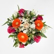 A vivid and joyful bouquet, gracefully arranged to reflect the serene beauty of Mill Hill's local landscapes, is displayed from a top-down angle on a pristine white background. Three orange Gerbera daisies, cheerful and full of energy, serve as focal points, their yellow-green hearts sparking immediate warmth and positivity. Curving between them are sumptuous roses-magenta and fuchsia in hue, both in full bloom and as promising buds-infusing the arrangement with a sense of affection and celebration. Near the centre, a single rose of pale peach-cream creates a soothing anchor of softness. White alstroemeria blossoms sweep through the design, their petals offering a delicate counterpoint to the bold colours, while clusters of fine white spray chrysanthemums add airy, gentle accents. All are set within a generous embrace of glossy dark foliage, giving the bouquet structure and a nod to the green charm of nearby Mill Hill Park. The natural interplay of colour, light, and texture makes this bouquet an uplifting, versatile choice-suitable for birthdays, anniversaries, or thoughtful gifts delivered throughout Mill Hill and its welcoming neighbourhoods.