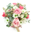 In this image, a delicate blush-pink hatbox sits serenely against a plain white background, overflowing with a dome of flowers that looks both polished and effortlessly natural, much like the quiet charm of Mill Hill's leafy avenues. The box is smooth and round, its pale pink softened further by a thin satin ribbon in a deeper rose shade wrapped around its middle. A cream rectangular tag is attached to the ribbon, carrying a small, refined logo that subtly suggests the hand of Flowers Mill Hill or a similar local expert. Above the rim, the bouquet blooms in harmonious tones of pink, white, and green. Light pink roses are generously scattered throughout, some fully bloomed with spiralling, velvety petals, others gently opening, their centres still tucked in, creating a feeling of unfolding tenderness. Between them, white daisy-like chrysanthemums with bright green centres pop cheerfully, giving the design a lively, uplifting energy. White alstroemerias, each petal decorated with purplish-red streaks and speckles, weave through the arrangement, adding detail and a slightly exotic flare that invites closer attention. The foliage is abundant yet measured: dusky, silvery-green eucalyptus leaves with rounded shapes offer a cool, matte backdrop, while darker, strappy leaves introduce depth and subtle arcs of movement. Tiny clusters of reddish-brown buds or small berries are dotted sparingly across the bouquet, lending a touch of woodland texture that feels at home in a neighbourhood close to Mill Hill's open spaces. The overall mood is one of gentle celebration and quiet affection, ideal for delivery to mark a birthday, a new home, or a simple thinking of you moment, bringing a soft breath of floral elegance into living rooms, kitchen tables, or office desks throughout the NW7 area.