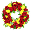 Against a spotless white background, this circular funeral wreath stands out with an elegant combination of colour and form. The ring is densely packed with deep red roses and bright yellow chrysanthemums, the flowers positioned so closely that they create a continuous band of rich, layered texture. The roses are the heart of the design, each bloom open enough to reveal its intricate spiral of velvety petals, with tones ranging from true crimson to deeper, wine-like shades that lend the tribute a sense of gravity and devotion. Nestled between the roses, the yellow chrysanthemums form rounded clusters, their many slender petals giving them a soft, feathery look that brightens the overall composition and introduces a note of gentle warmth. Fresh green foliage peeks out in carefully placed sections, with glossy dark leaves and paler, slightly silvery greens that suggest eucalyptus or a similar filler, adding dimension and a subtle, natural framing. The flowers and greenery form a flawless circular shape with an open centre, a traditional symbol of eternity and the continuing cycle of life, fitting for moments of remembrance and farewell. The neutral, even lighting ensures that every petal edge, every vein in the leaves, and every small variation in colour can be seen clearly, as though the wreath has just been prepared by an attentive florist. It is easy to imagine this arrangement created by a skilled team in Mill Hill, perhaps at Flowers Mill Hill, and delivered to a nearby chapel or cemetery, offering a composed, heartfelt expression of sympathy, remembrance, and enduring affection.