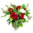 A sophisticated bouquet of red roses and white calla lilies is arranged in a clear glass vase and photographed against a pure white background, the kind of simple, elegant presentation you might picture in a carefully styled Mill Hill home. At the centre, about six or seven red roses bloom fully, their petals lush and velvety, folding outward in intricate spirals that reveal a deep, passionate crimson. The roses sit closely together, forming a rich, romantic heart to the design. Threaded among them, four or five calla lilies lift their heads with quiet poise. Each lily is a smooth, trumpet-shaped curve of creamy white, its surface softly reflecting the light and curling around a slender, golden-yellow spadix. This pairing of bold red and serene white is framed by an abundance of greenery that gives the bouquet texture and movement. Eucalyptus stems, with their slightly rounded, silvery-green leaves, add a light, airy touch, reminiscent of the gentle breeze across the open spaces of Mill Hill. Broader, glossy emerald leaves ring the composition, providing a verdant base that makes the central flowers stand out more vividly. The cylindrical glass vase, with a subtle ribbed detail at its base, is filled with clear water, revealing the straight green stems gathered cleanly inside. Bright, even lighting illuminates the arrangement, emphasizing the velvety sheen of the roses, the smooth surface of the lilies, and the fresh, crisp quality of the foliage. The overall mood is calm yet expressive, a bouquet perfectly suited to an anniversary dinner on a quiet Mill Hill side street or a romantic gesture delivered to a flat overlooking the gentle rise of the local hills, where a touch of floral artistry brings warmth and grace to the day.