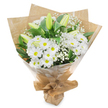 Set against a plain white background, this elegant white and green bouquet has a tranquil presence, like a quiet walk through Mill Hill's tree-lined streets on an overcast day. At the heart of the arrangement lie numerous white chrysanthemums with daisy-like blooms, each composed of fine, symmetrical petals that radiate cleanly from a fresh yellow-green centre. These flowers are grouped closely together, creating a soft, almost cushion-like appearance that feels both soothing and generous. Punctuating this base of daisies are several upright lily buds, slender and gracefully tapered, their petals still folded and shaded in pale green with delicate creamy tips. They lend vertical movement and a sense that the bouquet will continue to evolve after it reaches its recipient. Between the larger blooms, wisps of white baby's breath are artfully threaded, their tiny clustered blossoms giving an airy, cloud-soft finish that tempers the stronger shapes of the lilies and chrysanthemums. Surrounding everything is a frame of deep green foliage, shining lightly in the studio light and creating a rich contrast that highlights the purity of the white flowers. The hand-tied stems are wrapped in rustic brown kraft paper, its gently crinkled texture and warm tone echoing the simple, homely character of Mill Hill Broadway cafés and shops. Over this, a transparent cellophane layer encloses the bouquet, adding a subtle sheen and keeping the stems secure for delivery without hiding the craftsmanship beneath. The gathered base is neatly bound, forming a comfortable handle ready to carry to a service, a family home, or a hospital near Mill Hill East. Overall, the bouquet conveys quiet sympathy, hope, and gentle remembrance, offering a tender way to express care within the Mill Hill community.