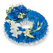 A circular funeral wreath composed with quiet precision: a dense ring of deep, royal-blue chrysanthemums forms the textured core, each tiny, spidery petal packed closely to make a plush, voluminous band of colour. The wreath rests on a pleated white satin ribbon that is softly ruffled along the inner and outer edges, its smooth sheen lifting the mood with a gentle, reflective brightness against the rich blue. At the upper-left curve, three large blue roses unfurl in full bloom - their velvety petals a saturated sapphire that echoes the chrysanthemums but reads as a larger, softer presence. Nestled around those roses are fine sprays of white baby's breath and a few dark green leaves, the tiny clouds of Gypsophila punctuating the composition with delicate lightness. From the mid-left, a graceful cascade of ivory-white orchids - the elongated, orchid-like faces of Phalaenopsis or Dendrobium - trails toward the lower right, the blooms seeming almost weightless as they arch across the blue base. Interspersed along that cascade are pale green orchid buds, some tightly closed and others beginning to open, suggesting renewal amid remembrance. The whole piece is arranged in cool, diffused light that emphasizes textures: the fuzzy chrysanthemum heads, the sumptuous rose velvet, the satin gleam of ribbon, and the silky orchid petals. The overall feeling is one of solemn beauty and dignified comfort, a sympathetic tribute designed for a memorial service in Mill Hill whether at a local chapel or graveside, conveying peaceful respect, purity, and enduring memory.
