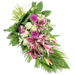 This elongated sympathy arrangement in tones of deep pink, white, and lush green is photographed against a plain white backdrop, which highlights the careful craftsmanship of the design. The spray is arranged on a diagonal, with the stems tied neatly at the top left and the blooms and foliage flowing gracefully toward the bottom right, forming a gentle teardrop or crescent silhouette. At its centre, large Oriental-style Stargazer lilies draw attention with their rich fuchsia-pink petals, crisp white edging, and detailed burgundy speckles, some blossoms fully open and others held in elegant green buds lightly flushed with pink. Tucked between them are bright magenta gerbera daisies that provide lively bursts of colour, balanced by an array of creamy white roses and soft, ruffled white carnations that lend a tranquil, soothing presence. Small white daisy-like filler flowers are scattered throughout, bringing in fine, light touches that break up the blocks of colour and enhance the sense of depth. The flowers rest on a foundation of mixed greenery: broad, glossy dark leaves offer support and structure, soft fern fronds extend gently outward like lace, and long, slender leaves arc and trail, accentuating the elongated form and creating a sense of gentle motion. The overall impression is one of quiet elegance and heartfelt respect, as if prepared in a Mill Hill floral studio not far from Arrandene Open Space, ready to be taken to a funeral at Hendon Crematorium or a memorial service in Mill Hill. This spray would make a comforting, dignified tribute, conveying sympathy, love, and remembrance to grieving families in the local area.
