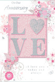 This anniversary card offers a gentle, intimate celebration of long-lasting romance, the kind a couple in Mill Hill might exchange after a quiet evening walk through the neighbourhood. The design blends soft pastel pinks with silvery greys to create a feeling of calm affection and treasured companionship. At its centre, the word LOVE is elegantly spelled out in raised, glittered letters that feel slightly cushioned to the touch. The subtle sparkle along the edges of each letter reflects light like delicate dew on petals in a morning garden. The letter O is transformed into a shimmering, silver-textured heart, adding a tender focal point without disturbing the harmony of the word. Surrounding this centrepiece, delicate blooms unfold in shades of blush and muted mauve, their outlines gentle and almost watercolor-soft. The flowers appear to be thoughtfully placed, like stems in a hand-arranged anniversary bouquet ready for delivery across Mill Hill. Swirling lines, scattered petals, and tiny butterfly details create a sense of movement and whimsy, reminiscent of an English spring garden stirred by a light breeze. The background, a soft pink wash, cradles the design, allowing the silver and floral elements to stand out. Phrases such as On Our Anniversary and I love you today and always are written in an understated, flowing script that carries genuine warmth and sincerity. The entire composition feels like a quiet tribute to shared journeys, capturing the tenderness of time spent together in Mill Hill, from everyday routines to cherished milestones marked year after year.